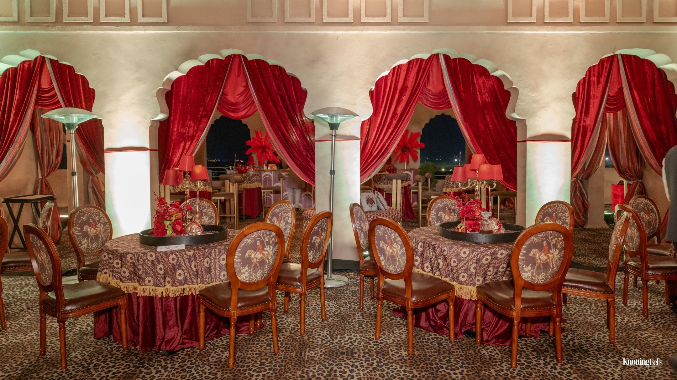Divine Sinners elegant ballroom with red drapes and ornate seating